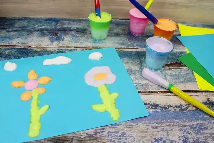a photo of diy puffy paint craft of flowers and clouds