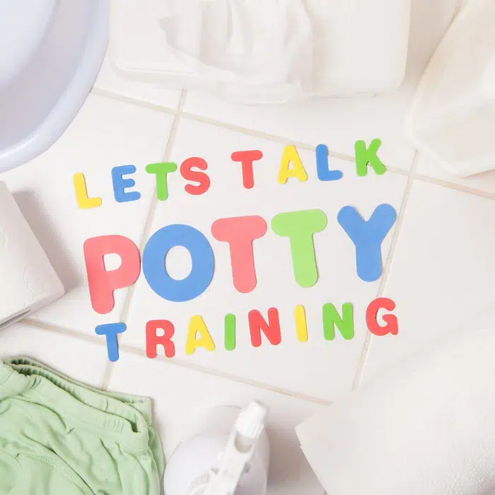 a photo of a bathroom floor with letters that spell "let's talk potty training"