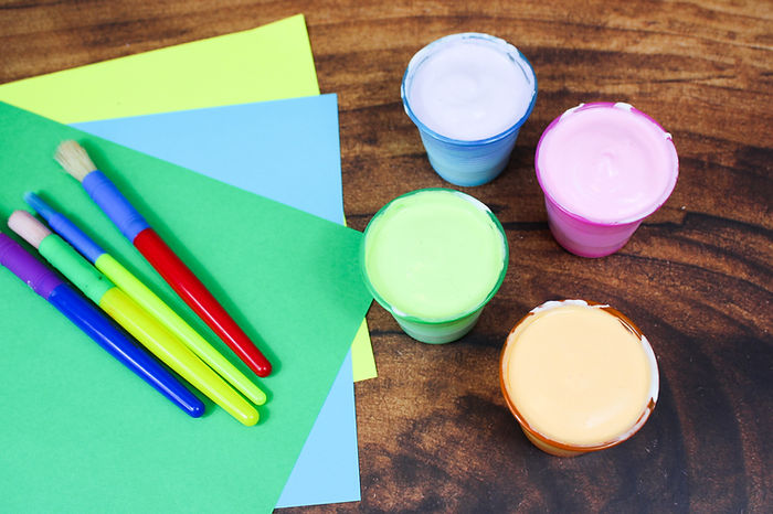 a photo of the four containerss with colored puffy paint.