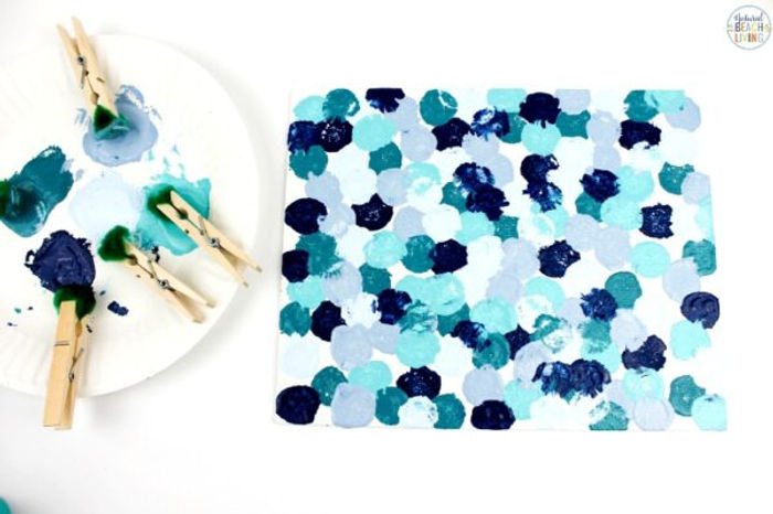 A photo of art made with clothespins and paint