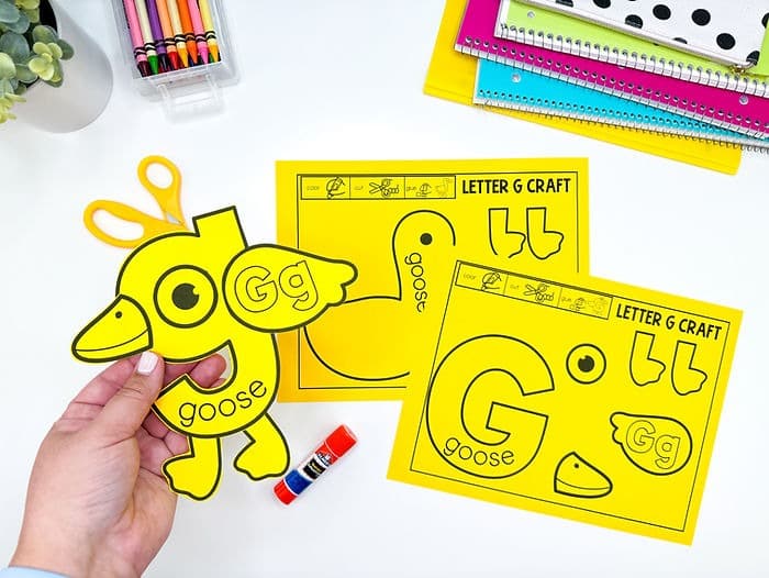 A photo of alphabet crafts for the letter g. There are 3 goose crafts.