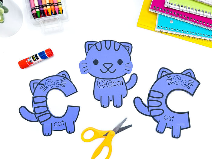 A photo of the letter c alphabet crafts. There are 3 cat crafts.