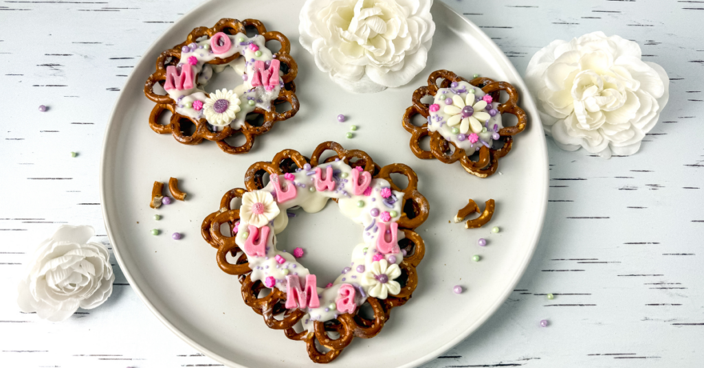 a pretzel wreath with icing, sprinkles, and edible letters 