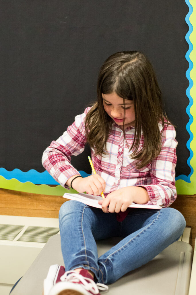 A-Z Summer Words - Cultivating Brilliant Minds kid writing in a notebook