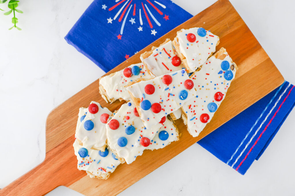 Fourth of July Crack Candy - Cultivating Brilliant Minds crackers with white chocolate and red and blue m&ms