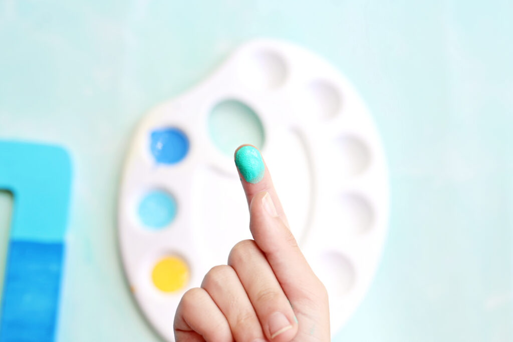 Dip Finger in Paint - Cultivating Brilliant Minds adding fingerprint fish