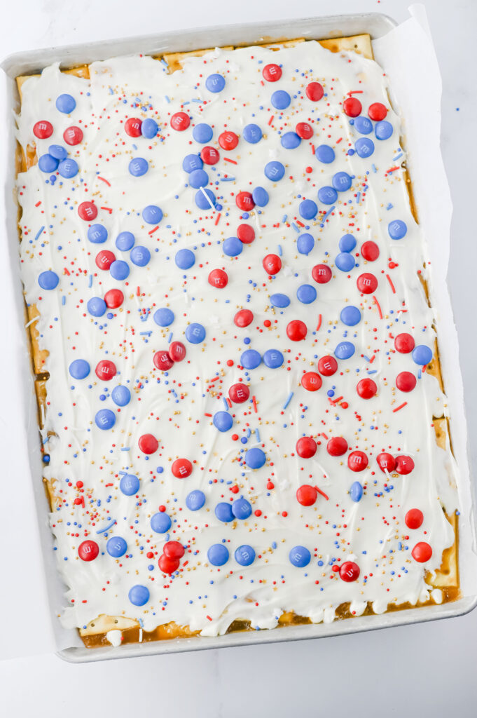 Fourth of July Crack Candy - Cultivating Brilliant Minds crackers covered in white chocolate and red and blue m&ms