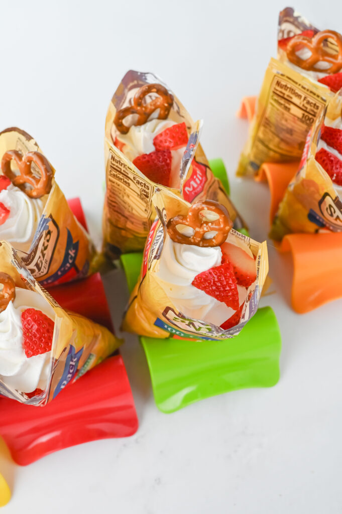 walkingstrawberrypretzelsalads6 - Cultivating Brilliant Minds adding the cool whip and toppings