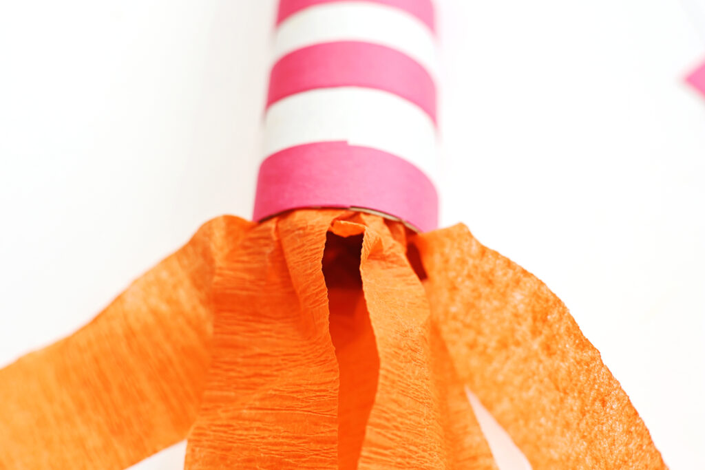 Glue Streamers to Inside Bottom of Paper Roll - Cultivating Brilliant Minds firecracker rocket craft