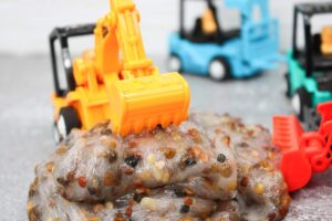 pebble slime with toy construction vehicles