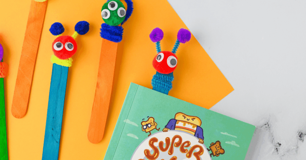 monster bookmarks made out of colored popsicle sticks, pipe cleaners, and pom poms