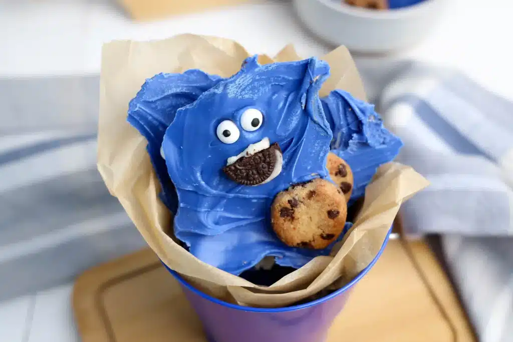Cookie Monster Bark - Cultivating Brilliant Minds chocolate bark dyed blue with cookies and a face to look like the cookie monster