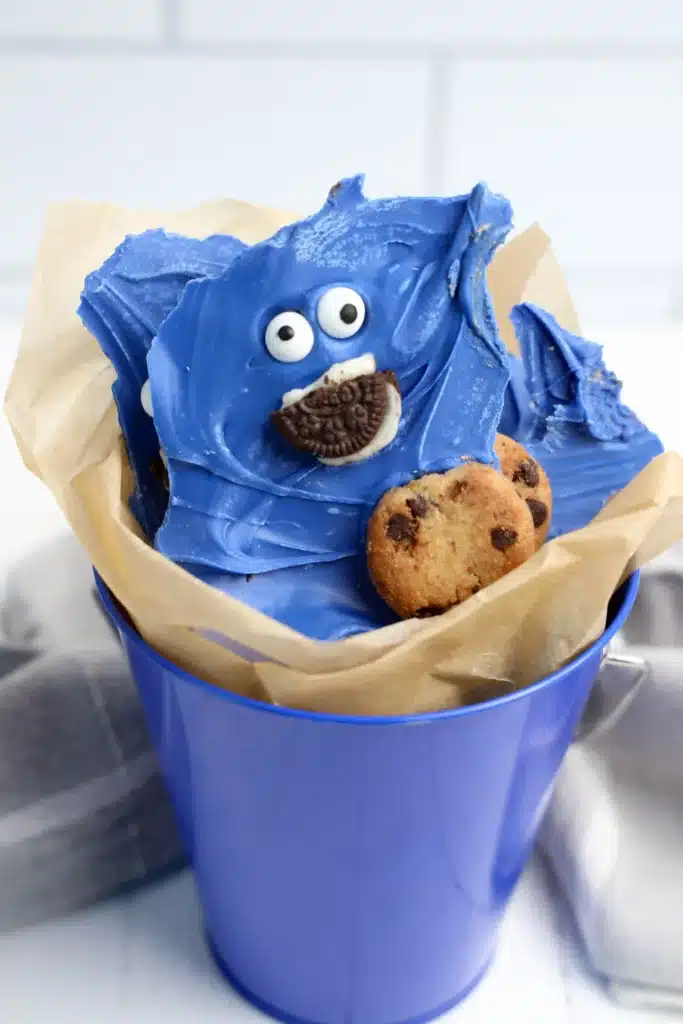 Cookie Monster Bark - Cultivating Brilliant Minds chocolate bark dyed blue with cookies and a face to look like the cookie monster