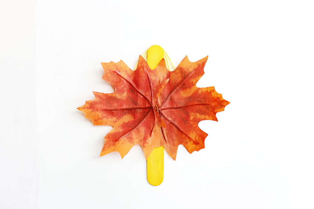 Glue Leaves to the Back of Popsicle Stick - Cultivating Brilliant Minds this leaf craft for kids needs some fairy wings! glue the leaf to the back.