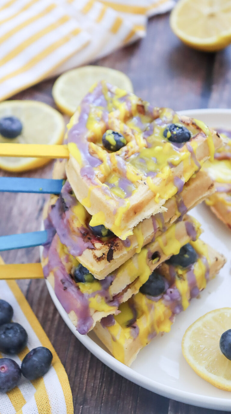 blueberry lemon waffle pops on sticks stacked on top of each other