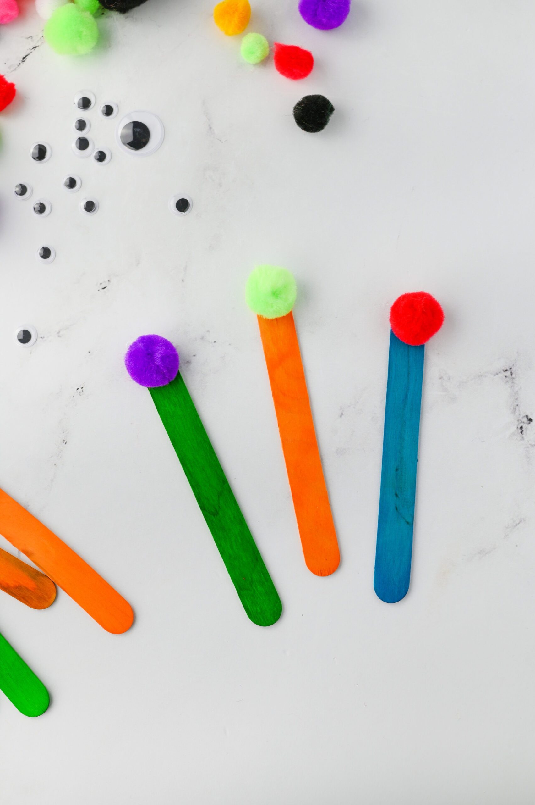 monsterbookmark2 - Cultivating Brilliant Minds to make the monster bookmark, glue a pom pom onto the top of a colored popsicle stick