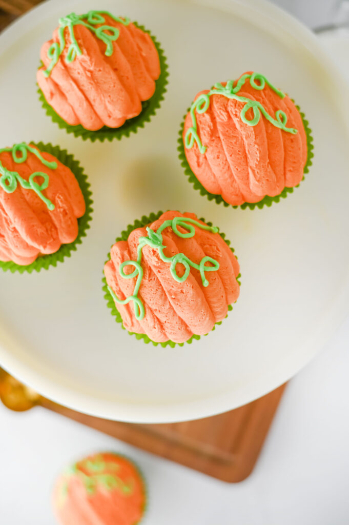 3pumpkincupcakes2 - Cultivating Brilliant Minds pumpkin cupcakes decorated to look like pumpkins on a cake stand in a kitchen