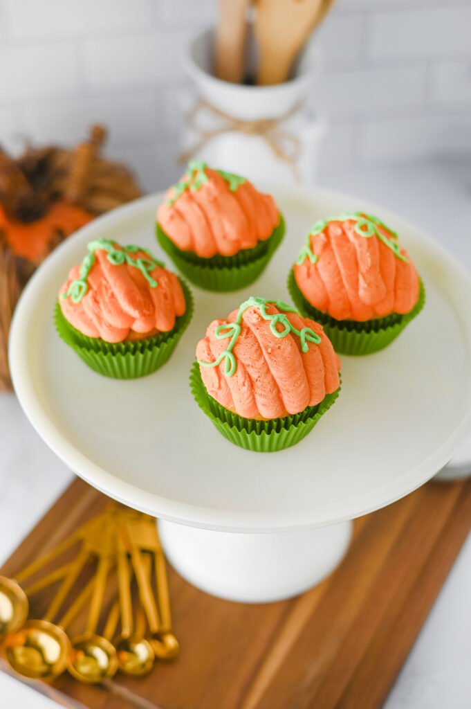3pumpkincupcakes5 - Cultivating Brilliant Minds pumpkin cupcakes decorated to look like pumpkins on a cake stand in a kitchen