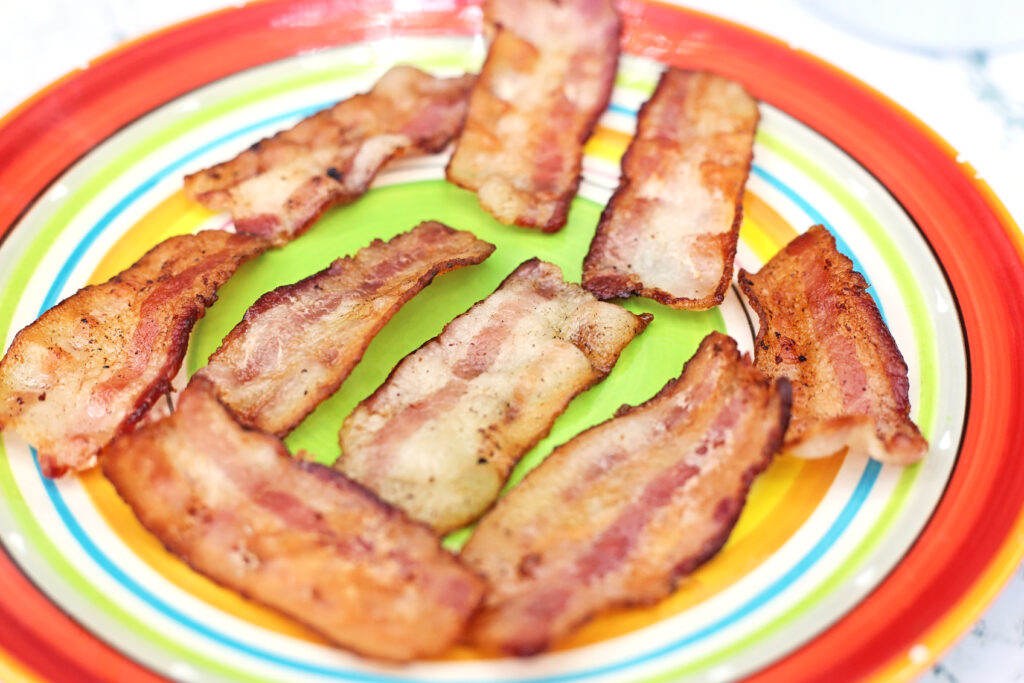 Bacon - Cultivating Brilliant Minds cooked bacon on a multicolored plate