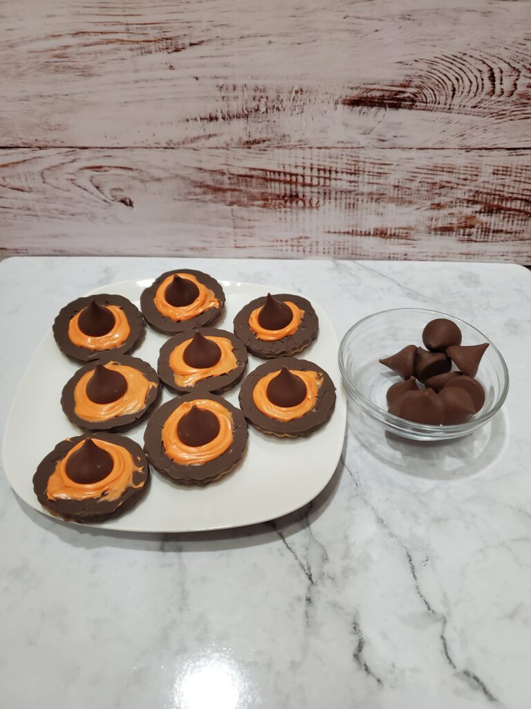 Copy of 20230924_101839 - Cultivating Brilliant Minds striped cookies with orange icing and a hershey kiss on top