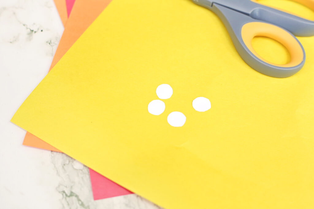 Cut White Circles - Cultivating Brilliant Minds a close up of two white circles cut out for eyes