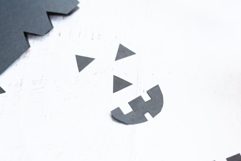 Cut out jack o lantern shapes - Cultivating Brilliant Minds jack-o-lantern face cut out of black construction paper
