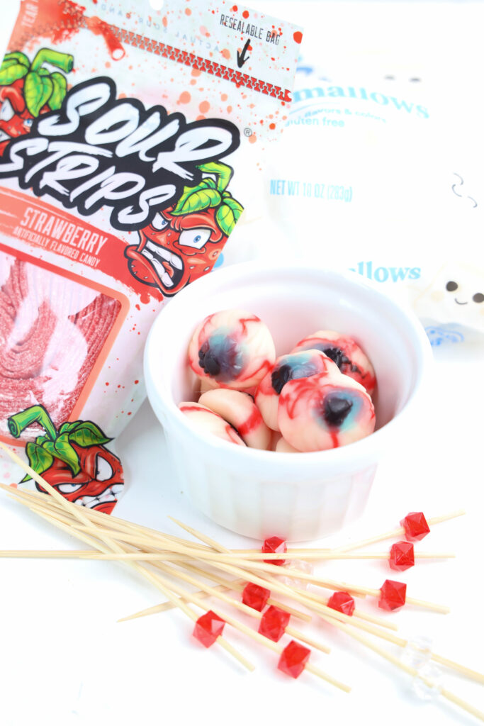 Eyeball Candy Cups - Cultivating Brilliant Minds candy eyeballs in a jar with skewer toothpicks