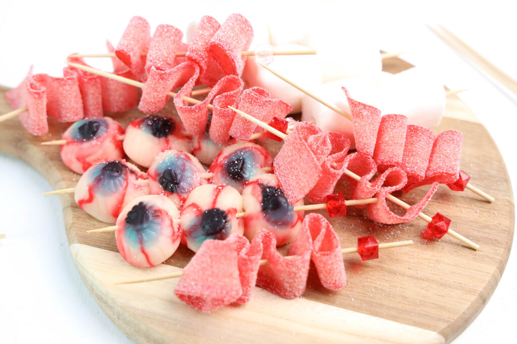 Eyeball Candy Cups - Cultivating Brilliant Minds Eye ball candies and sour gummy strips on skewers