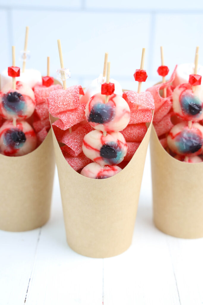Eyeball Candy Cups - Cultivating Brilliant Minds Eyeball Candy Cups filled with gummies on skewers
