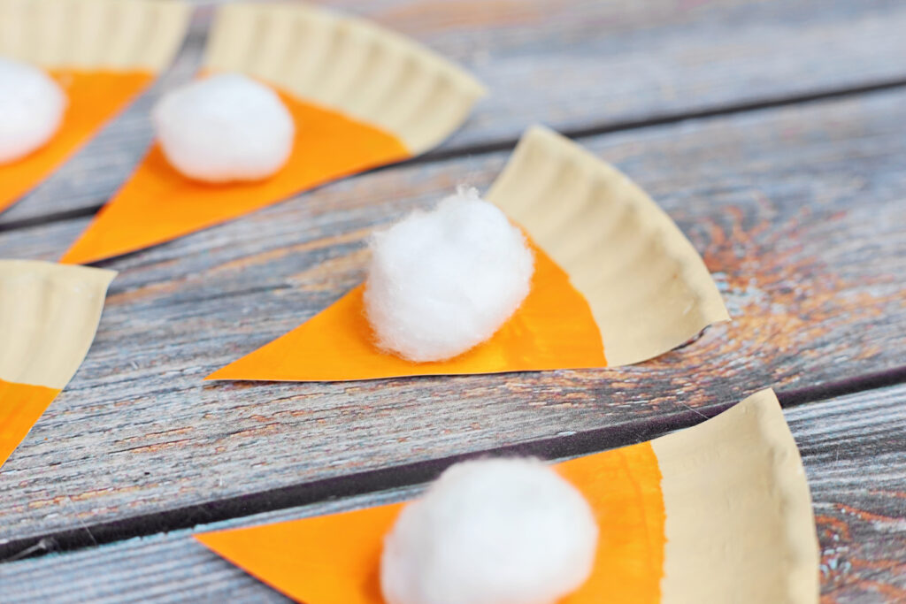 Glue Cotton Ball - Cultivating Brilliant Minds painted paper plate pieces with a cotton ball glued on