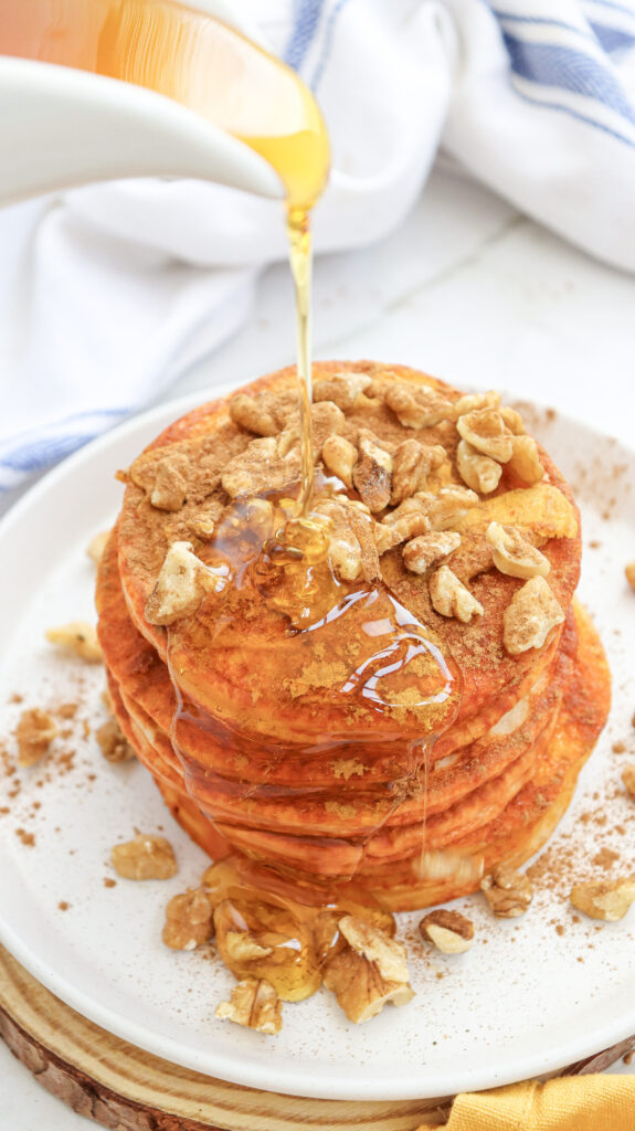 Pumpkin Pancakes - Cultivating Brilliant Minds pouring syrup on pumpkin pancakes