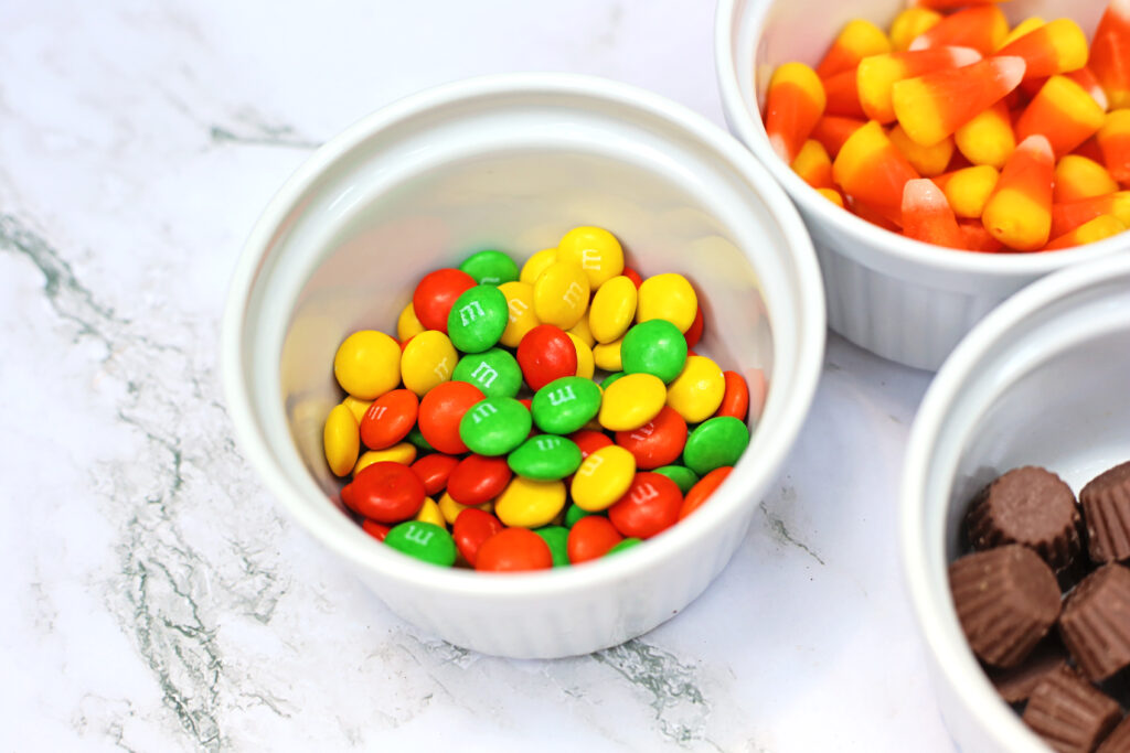 MMs - Cultivating Brilliant Minds a close up of chocolate candies, candy corn, and peanut butter cups