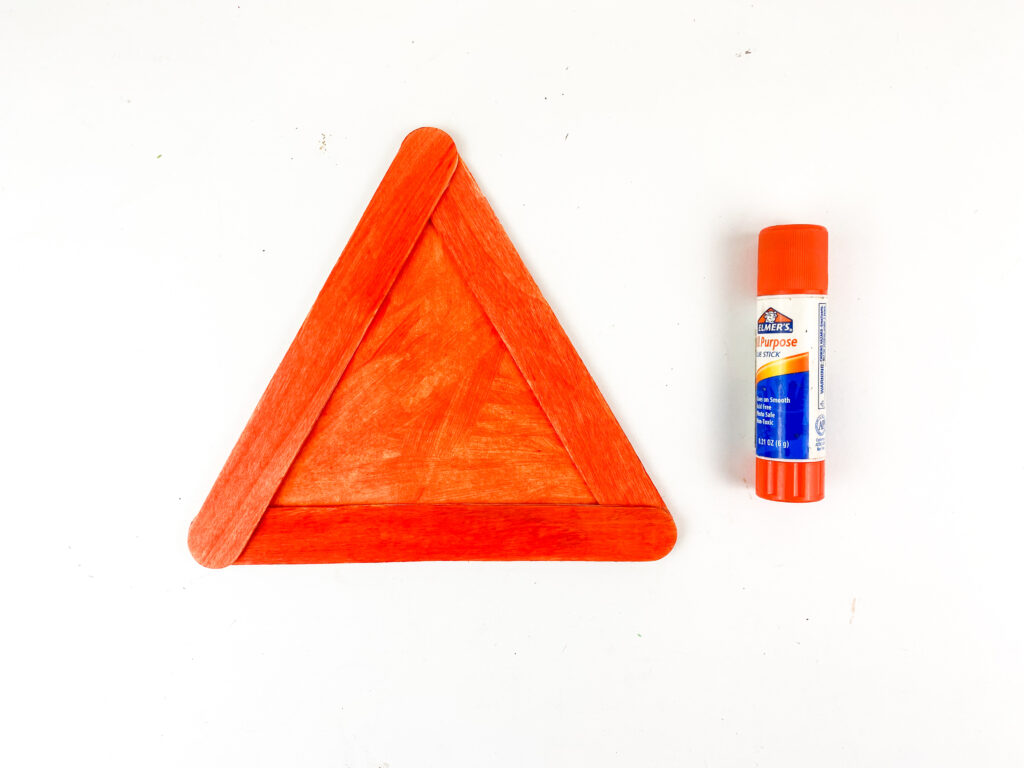 Photo 7-1-25 11 49 33 PM - Cultivating Brilliant Minds 3 orange popsicles sticks glued into a triangle