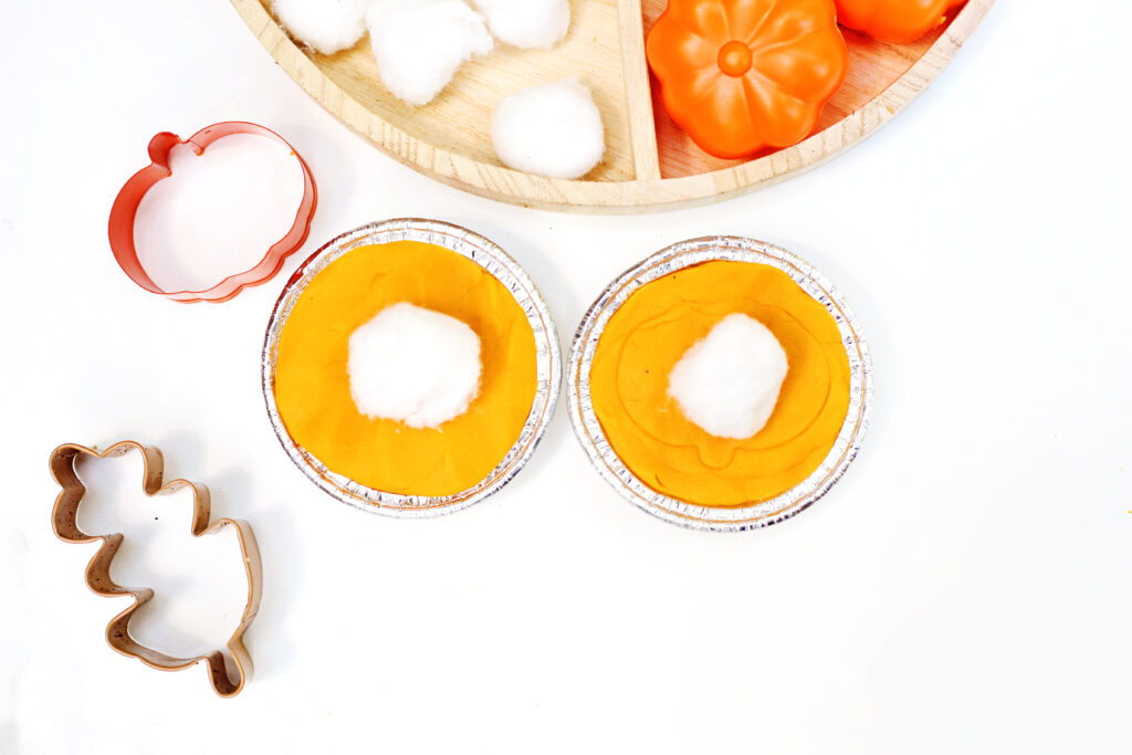Pumpkin Pie Playdough Tray 4 - Cultivating Brilliant Minds playdough pumpkin pies with a cotton ball to represent whipped topping