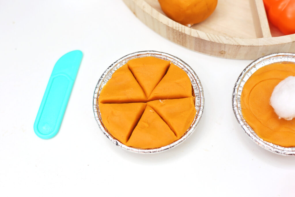 Pumpkin Pie Playdough Tray 8 - Cultivating Brilliant Minds playdough in an aluminum tray cut into slices of pie