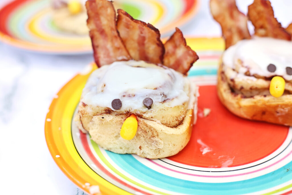 Turkey Cinnamon Rolls Final 3 - Cultivating Brilliant Minds turkey cinnamon rolls on a multicolored plate