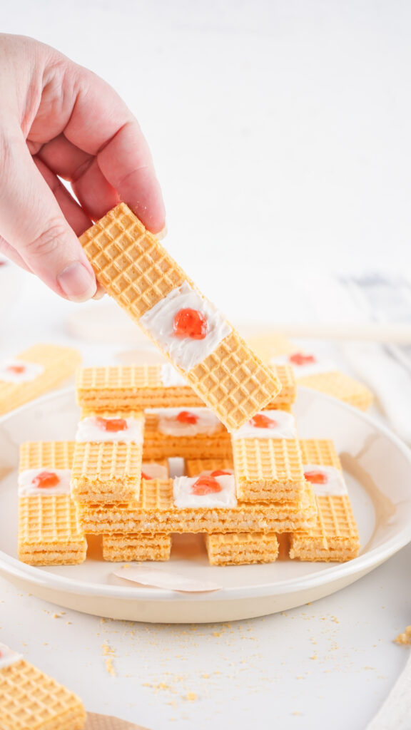 bandaid cookies-03 - Cultivating Brilliant Minds picking up a band-aid cookie off a plate