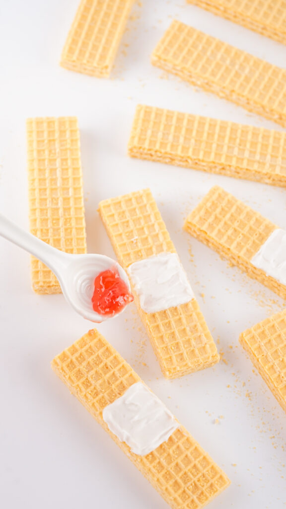 bandaid cookies-17 - Cultivating Brilliant Minds add the jelly to the wafer cookies