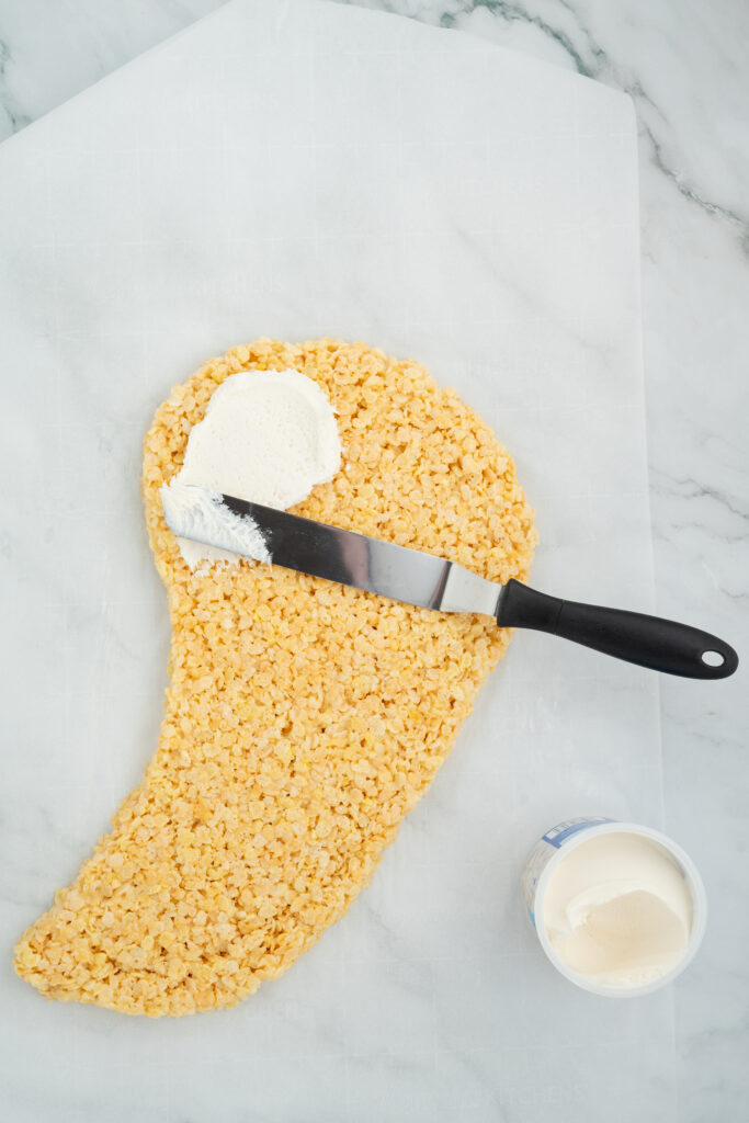 ghostricekrispiecake-08296 - Cultivating Brilliant Minds melt the white candy coating and spread on the rice krispies