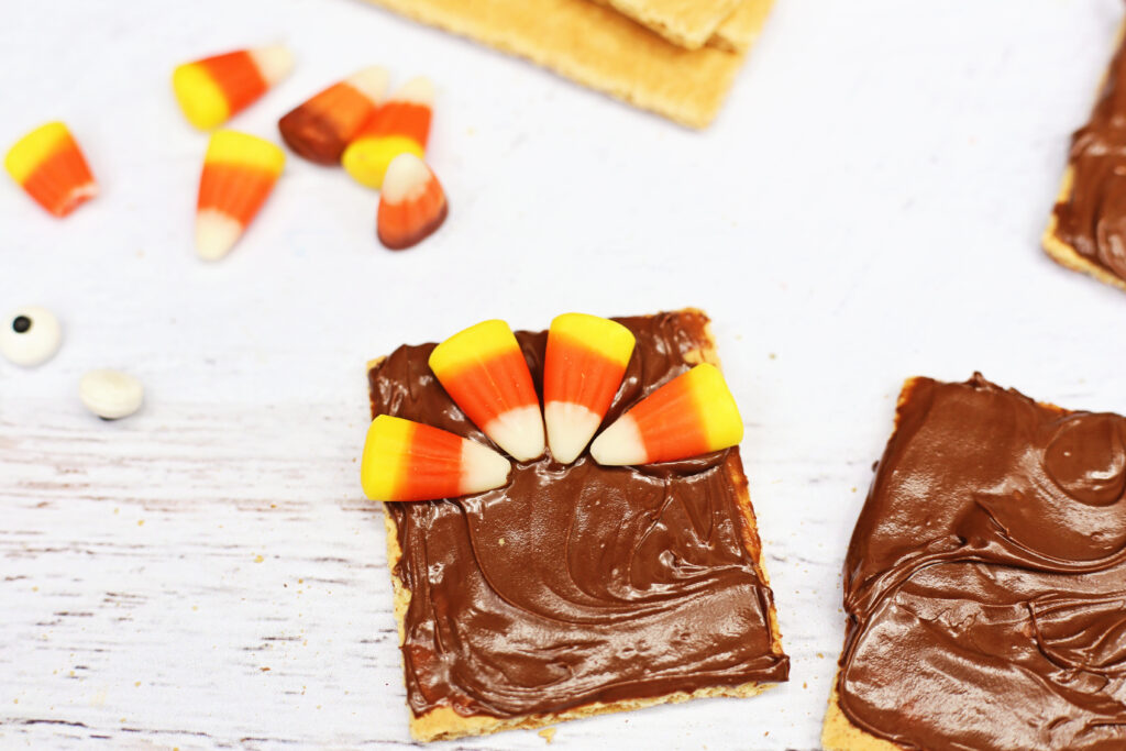 Graham Cracker Turkey - Cultivating Brilliant Minds graham crackers smeared with nutella and candy corn on top