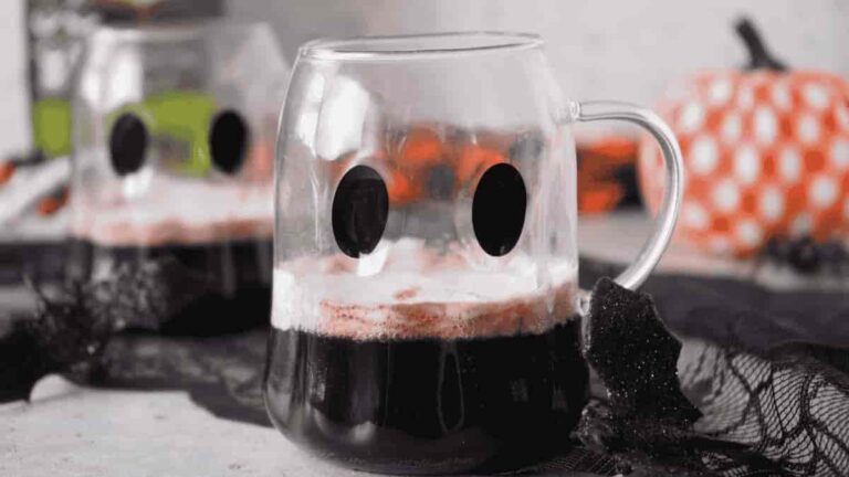 Black halloween punch in a clear ghost mug