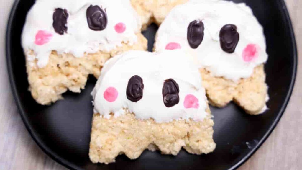 rice kripsie treats shaped like a ghost with white icing