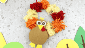 A thanksgiving turkey wreath craft using yarn