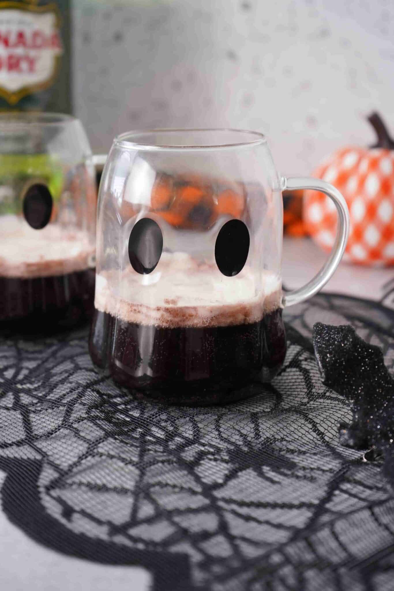 Black halloween punch in a clear ghost mug