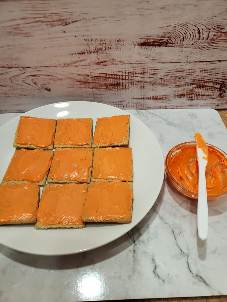Spookley the Square Pumpkin Graham Crackers - Cultivating Brilliant Minds Spread the orange icing on the crackers