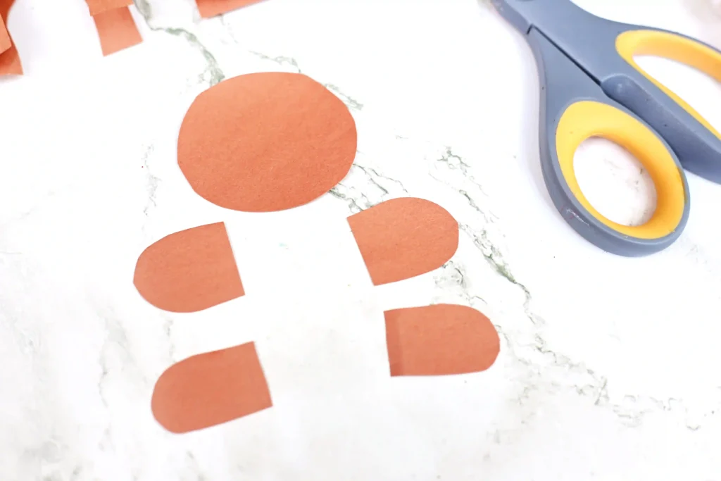 Pieces of a gingerbread cut out of construction paper