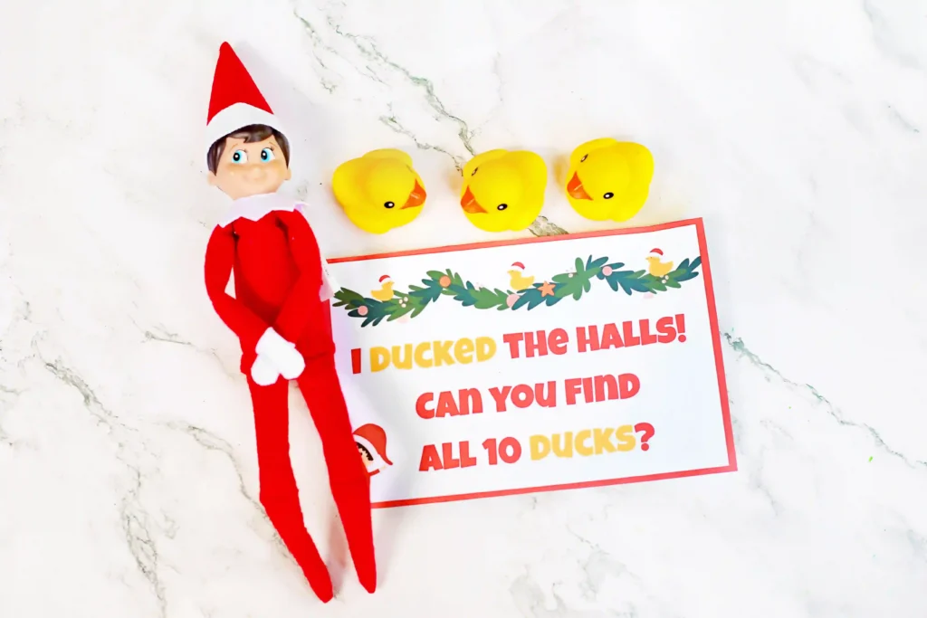 Elf on the Shelf Idea - Cultivating Brilliant Minds an elf on the shelf next to 3 ducks with a sign that reads "I ducked the halls! Can you find all 10 ducks?"