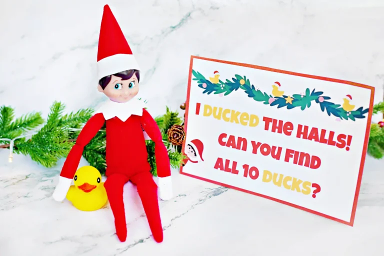an elf on the shelf next to a duck with a sign that reads "I ducked the halls! Can you find all 10 ducks?"