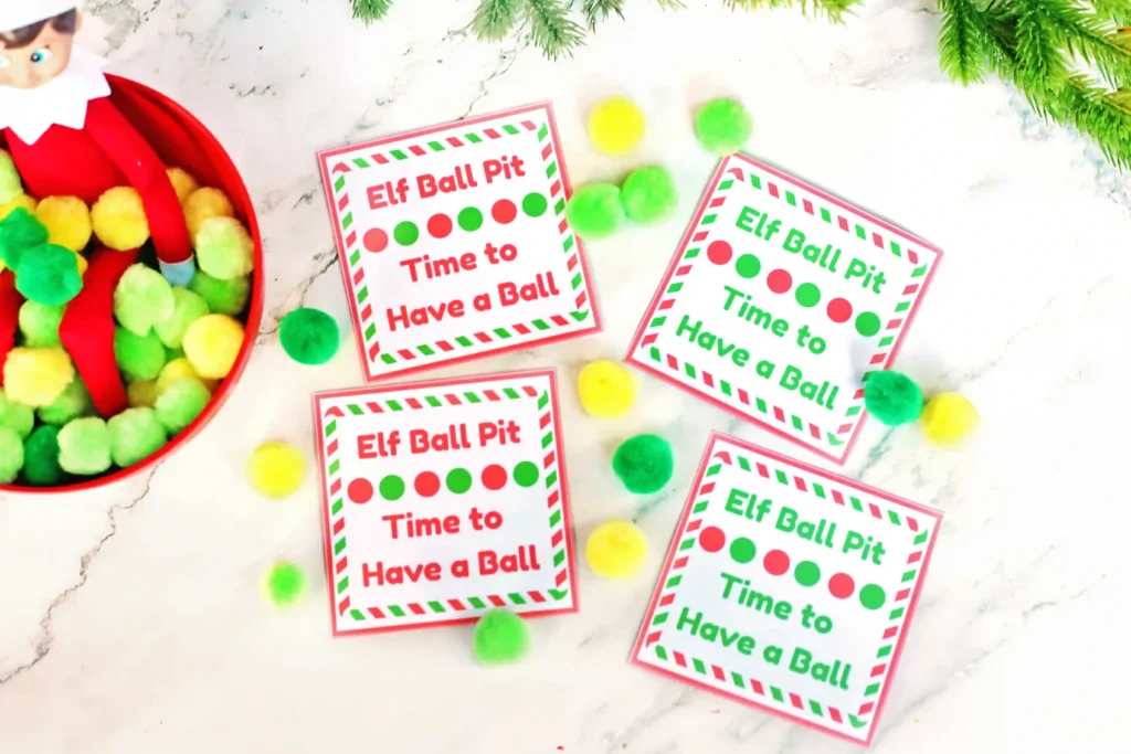 Elf on the Shelf Idea - Cultivating Brilliant Minds elf on the shelf in a bowl of pom poms with a sign that reads "elf ball pit - time to have a ball"