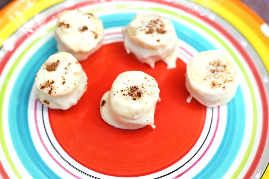 Fall Banana Bites - Cultivating Brilliant Minds Bananas dipped in white chocolate with pumpkin spice sprinkled on top
